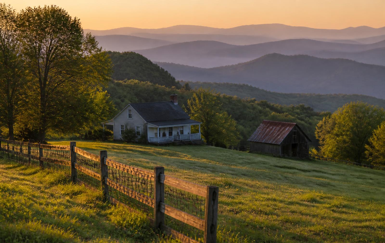 Farmhouse, barn and pasture with the Smoky Mountain ridges behind, East Tennessee